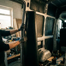 Acoustic rubber soundproofing sheet being installed in van interior by specialist