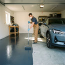 Epoxy garage floor paint being applied - before and after transformation in UK garage