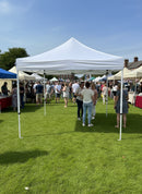 Heavy duty steel frame gazebo erected at UK outdoor trade show event with white canopy