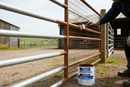 Professional applying Industrial Supplies Co High Build Vinyl Paint to galvanised farm gate